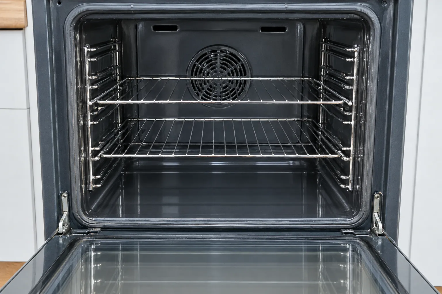 The same oven after a deep clean, with clean enamel and gleaming racks